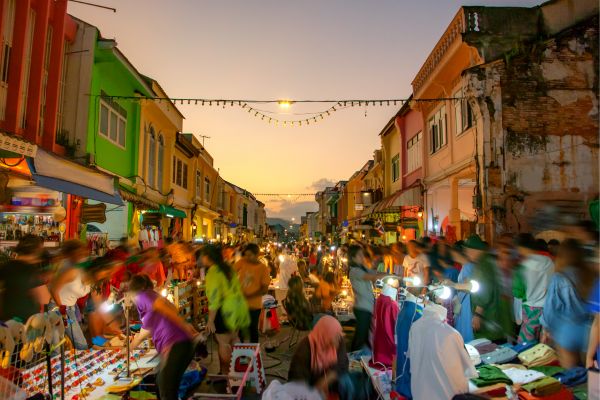 Busy Gaya Street with colorful stalls and people shopping


