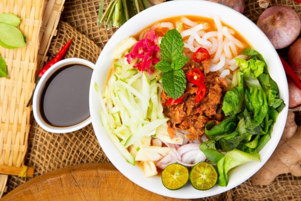 A bowl of Sabahan laksa on a table.

