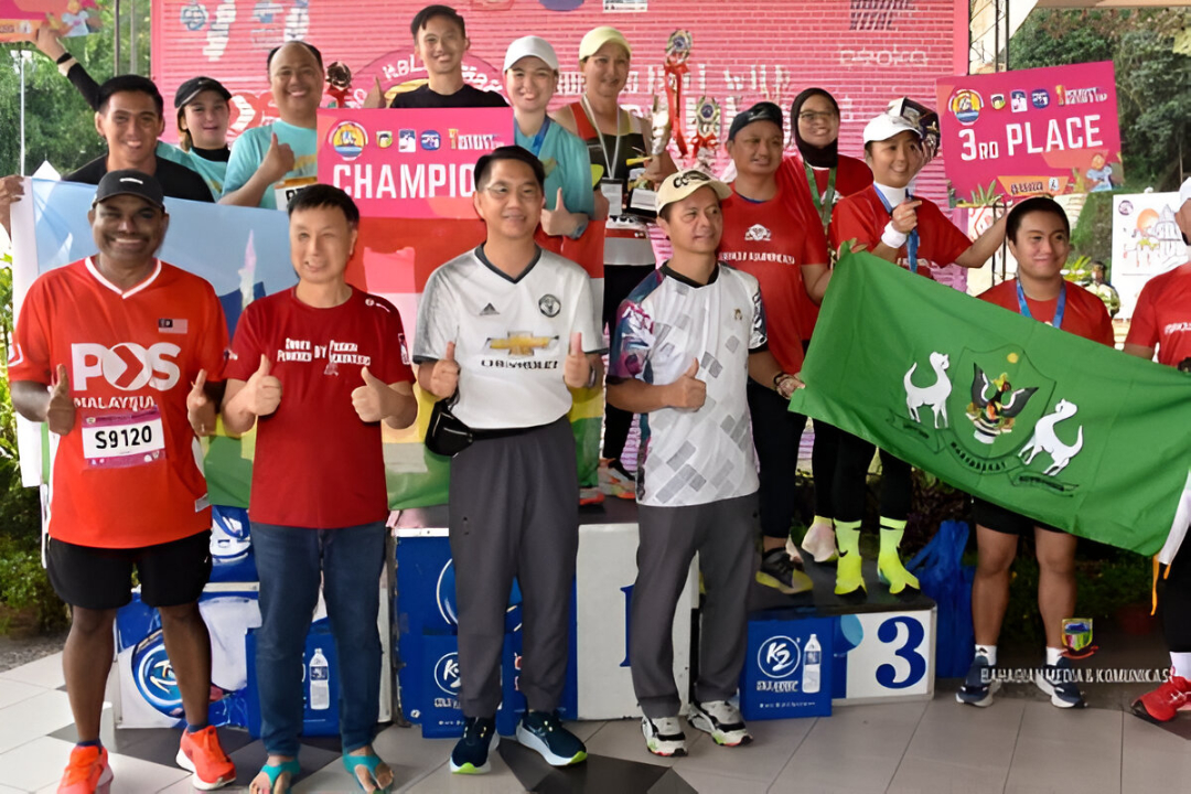 The Borneo Half Marathon winners happily receiving their medals on the podium.